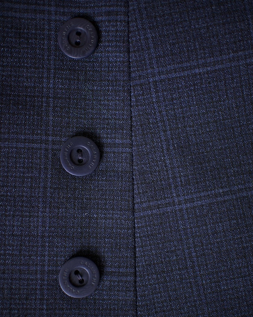 Close-up of a dark blue textured fabric with buttons