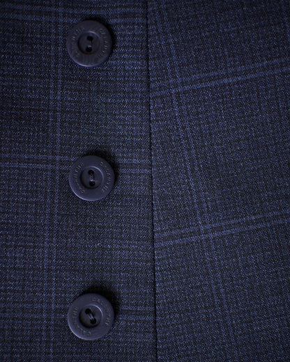 Close-up of a dark blue textured fabric with buttons